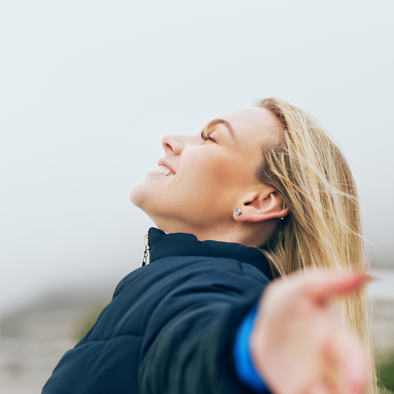 Lady spreading her hands and smiling