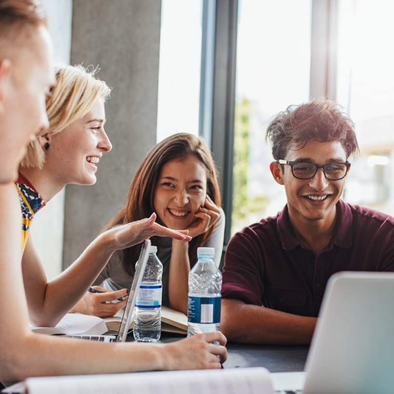 A group of professionals engaged in a discussion around a table, analyzing various retail challenges and brainstorming solutions to improve business performance
